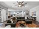 Inviting living room with a cozy sectional, wood floors, and an open layout connecting to the kitchen and dining area at 2514 E Pleasant Ln, Phoenix, AZ 85042