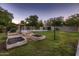 Large grassy backyard with an in-ground pool, gazebo, garden boxes, and clothesline at 2518 E Flower E St, Phoenix, AZ 85016
