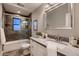 Well-appointed bathroom with a tub and shower combo, vanity, and a decorative mirror at 2518 E Flower E St, Phoenix, AZ 85016
