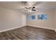 Spacious bedroom with hardwood floors, neutral paint, ceiling fan, and lots of natural light at 2518 E Flower E St, Phoenix, AZ 85016