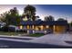 Charming home featuring a well-manicured front yard with mature trees and a convenient carport for covered parking at 2518 E Flower E St, Phoenix, AZ 85016