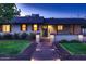 Charming single story home featuring a brick walkway, trimmed bushes, and a wreath on the front door at 2518 E Flower E St, Phoenix, AZ 85016
