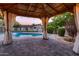 Relaxing backyard gazebo overlooking a sparkling in-ground pool and landscaped yard at dusk at 2518 E Flower E St, Phoenix, AZ 85016