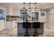Stylish kitchen boasting a large island, stainless steel refrigerator, patterned backsplash, and tile floors at 2518 E Flower E St, Phoenix, AZ 85016