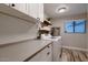 Bright laundry room with white cabinets, quartz countertop, and modern washer and dryer at 2518 E Flower E St, Phoenix, AZ 85016