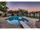 In-ground swimming pool with diving board, concrete decking, and black metal safety fence at 2518 E Flower E St, Phoenix, AZ 85016