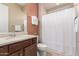 Bathroom featuring a white shower curtain, neutral countertops, and warm earth tones at 26161 W Siesta Ln, Buckeye, AZ 85396