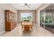 Bright dining room with a wood table, hutch, tile floors, and sliding glass doors to backyard at 26161 W Siesta Ln, Buckeye, AZ 85396