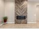 Stylish fireplace with a decorative wood accent wall feature at 26161 W Siesta Ln, Buckeye, AZ 85396