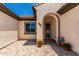 Inviting front porch with paver flooring and a decorative welcome pillow at 26161 W Siesta Ln, Buckeye, AZ 85396