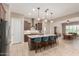 Open kitchen with counter seating flowing into the adjacent dining area at 26161 W Siesta Ln, Buckeye, AZ 85396