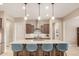 Bright kitchen featuring a spacious island with counter seating and modern fixtures at 26161 W Siesta Ln, Buckeye, AZ 85396