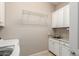 Clean laundry room with granite countertops and ample cabinet space at 26161 W Siesta Ln, Buckeye, AZ 85396