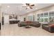 Open-concept living room with a kitchen view and comfortable leather seating at 26161 W Siesta Ln, Buckeye, AZ 85396