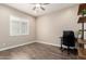 Bright office space with laminate floors, natural light, and a modern office chair at 26161 W Siesta Ln, Buckeye, AZ 85396