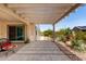 Covered patio with a pergola, pavers, and lush desert landscaping at 26161 W Siesta Ln, Buckeye, AZ 85396