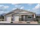 Charming single-story home featuring a symmetrical facade, dual garages, and stone accents, creating an inviting curb appeal at 2654 E Rustler Rd, San Tan Valley, AZ 85140