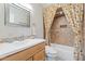 Bathroom with vanity, decorative mirror, and tiled shower with colorful shower curtain at 2727 W Ocaso Cir, Mesa, AZ 85202