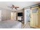 Bedroom featuring a large bed, wood floors, sliding patio door, TV, and barn door to bathroom at 2727 W Ocaso Cir, Mesa, AZ 85202