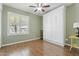 This charming room features a ceiling fan, a window, and a white Murphy bed, with wood look tile floors at 2727 W Ocaso Cir, Mesa, AZ 85202