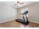 This room features a wood look tile floor, ceiling fan, and a treadmill at 2727 W Ocaso Cir, Mesa, AZ 85202