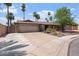 Charming single-story home with mature trees, a two-car garage, and a well-kept lawn at 2727 W Ocaso Cir, Mesa, AZ 85202