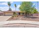 Charming single-story home with a well-manicured yard, desert landscaping, and attached two-car garage at 2727 W Ocaso Cir, Mesa, AZ 85202