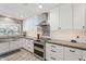 Bright kitchen featuring white cabinetry, stainless steel appliances, and modern backsplash at 2727 W Ocaso Cir, Mesa, AZ 85202