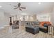 Spacious living room with wood-look floors and open floor plan into the kitchen at 2727 W Ocaso Cir, Mesa, AZ 85202