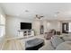 Open-concept living room featuring wood-look floors and a ceiling fan at 2727 W Ocaso Cir, Mesa, AZ 85202