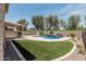 Serene backyard oasis with mature landscaping, pool and spa, artificial turf, and covered patio at 28263 N Welton Pl, San Tan Valley, AZ 85143
