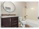 Bathroom featuring a bathtub, single sink vanity with drawers, and decorative backsplash at 28263 N Welton Pl, San Tan Valley, AZ 85143