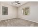 Bedroom featuring neutral walls, ceiling fan, carpet, and ample natural light through two windows at 28263 N Welton Pl, San Tan Valley, AZ 85143