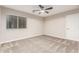 Bedroom featuring neutral walls, ceiling fan, carpet, and ample natural light through a window at 28263 N Welton Pl, San Tan Valley, AZ 85143