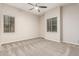 Neutral bedroom with carpet, ceiling fan and large windows providing ample natural light at 28263 N Welton Pl, San Tan Valley, AZ 85143