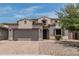 Charming two-story home boasts a tile roof, two-car garage, and desert landscaping at 28263 N Welton Pl, San Tan Valley, AZ 85143