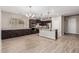 Open kitchen featuring wood-look tile floors, dark cabinets, and stainless steel appliances at 28263 N Welton Pl, San Tan Valley, AZ 85143