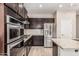Gourmet kitchen featuring stainless appliances, gas cooktop, tiled backsplash and granite countertops at 28263 N Welton Pl, San Tan Valley, AZ 85143