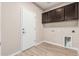 Utility room features tile floor, overhead cabinets, and washer/dryer hookups at 28263 N Welton Pl, San Tan Valley, AZ 85143