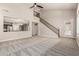Open living room with ceiling fan, stairs and view into the kitchen at 28263 N Welton Pl, San Tan Valley, AZ 85143