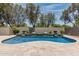 Sparkling pool and spa with a rock waterfall surrounded by lush desert landscaping at 28263 N Welton Pl, San Tan Valley, AZ 85143