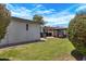 Spacious backyard showcasing a lush lawn, a grilling area with an umbrella, and a charming fire pit area at 3007 N 84Th Pl, Scottsdale, AZ 85251