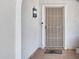 Close-up of the front door area featuring a security screen, video doorbell, and 'Welcome' doormat at 3007 N 84Th Pl, Scottsdale, AZ 85251