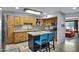 Well-lit kitchen featuring custom wood cabinetry, granite countertops, and a functional island with seating at 3007 N 84Th Pl, Scottsdale, AZ 85251
