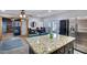 Open-concept kitchen and dining area with a granite island, stainless appliances, and access to the backyard at 3007 N 84Th Pl, Scottsdale, AZ 85251