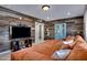 Spacious living room featuring a reclaimed wood wall, modern entertainment center, and comfortable seating at 3007 N 84Th Pl, Scottsdale, AZ 85251