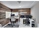 Home office featuring rustic wood accent wall, modern desks, and ample natural light at 3007 N 84Th Pl, Scottsdale, AZ 85251