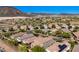 Beautiful aerial view showcasing the backs of desert homes with backyard landscaping and desert scenery at 32096 N 132Nd Dr, Peoria, AZ 85383