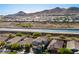 Panoramic aerial captures the desert homes in a community with access to the canal and mountains at 32096 N 132Nd Dr, Peoria, AZ 85383