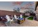 Well-kept backyard with seating around a fire pit and lush artificial grass for relaxing outdoor enjoyment at 32096 N 132Nd Dr, Peoria, AZ 85383